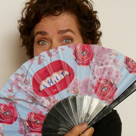 Woman carrying a fan decorated with a big red lip