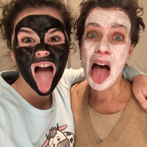 Funny mon and daughter wearing a black and a white beauty mask