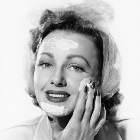 vintage photo of a woman applying cream on her face