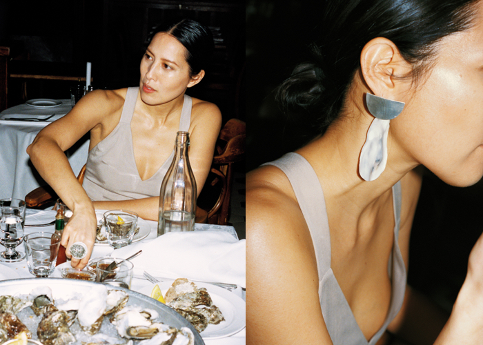 model eating oysters and wearing oyster earring from jewellery designer mia larsson