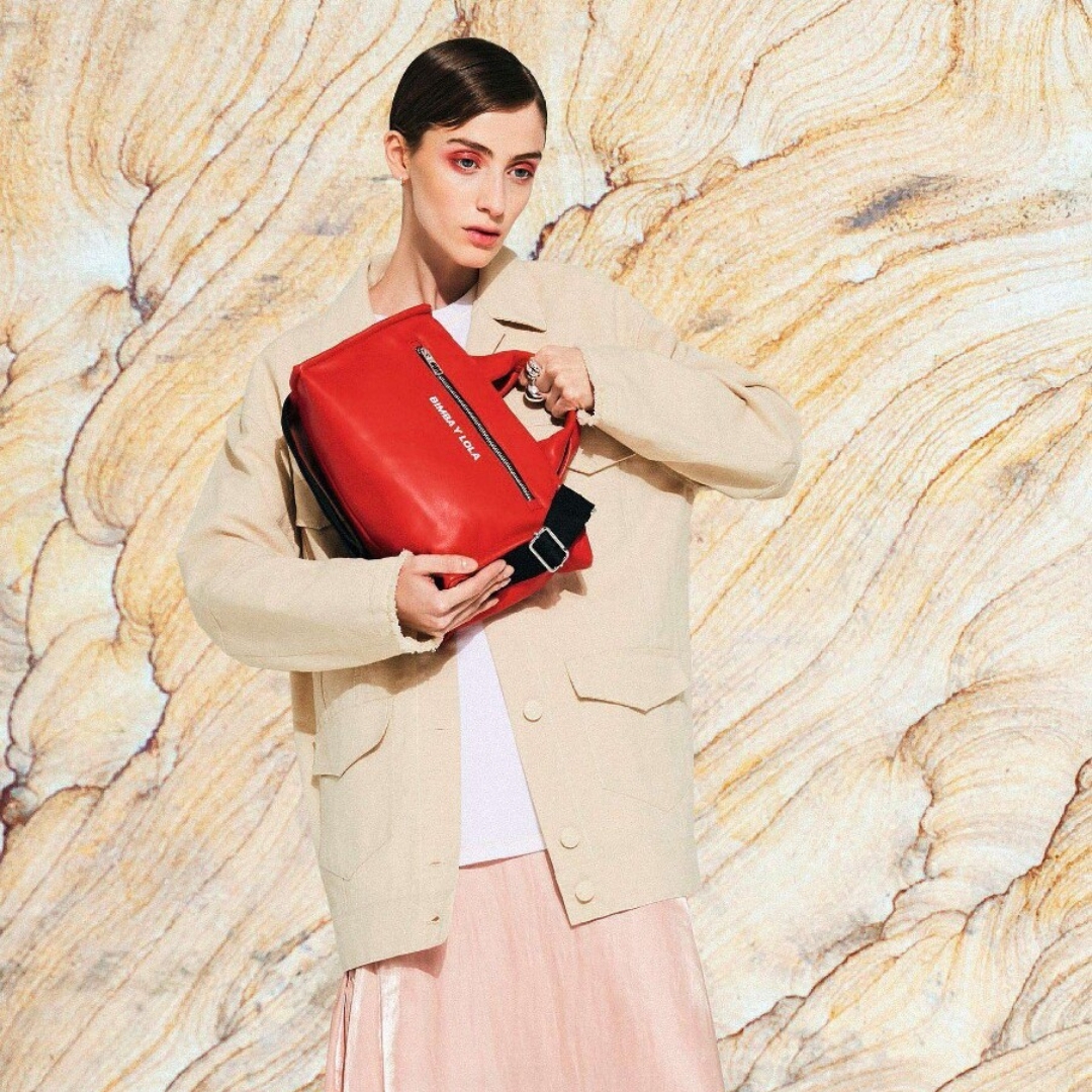 Model carrying a red bag from Spanish brand Bimba y Lola from 2019 collection