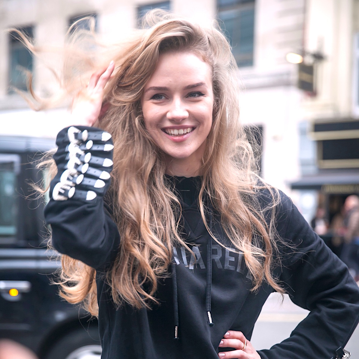 young woman with long hair, wearing all black outfit