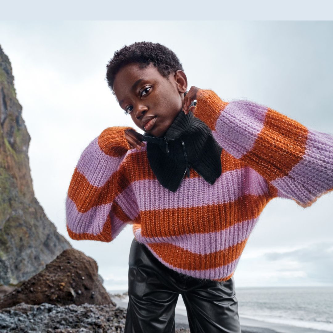 Selected Femme model show the new pullovers for AW 22-23 on a beach with foggy weather