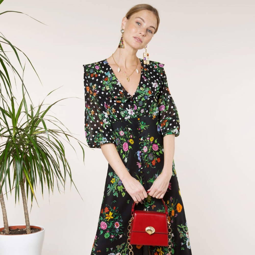 Woman wearing a floral dress by Rixo, one of the new brands on our radar.