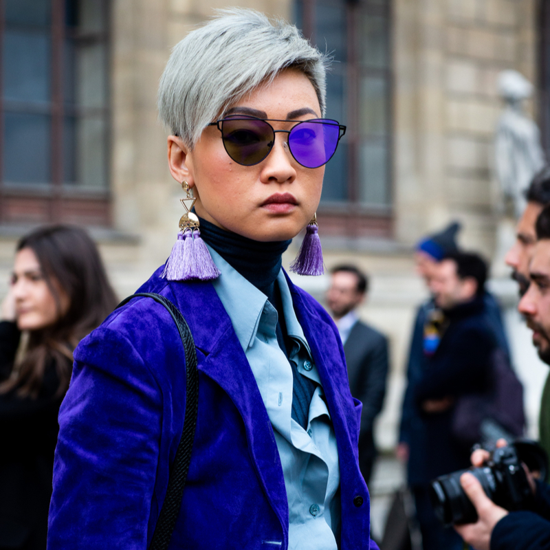 Fashionista Esther Queks at Milan Fashion Week wearing a cobalt blue suit and Dior sunglasses