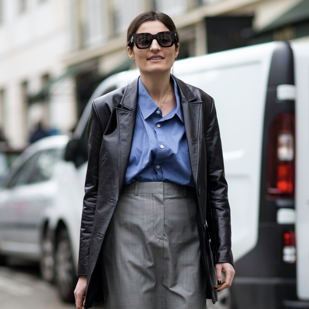 What to wear for a job interview-fashionista during Paris fashion week wearing a black leather blazer, blue shirt and a gray plaid skirt