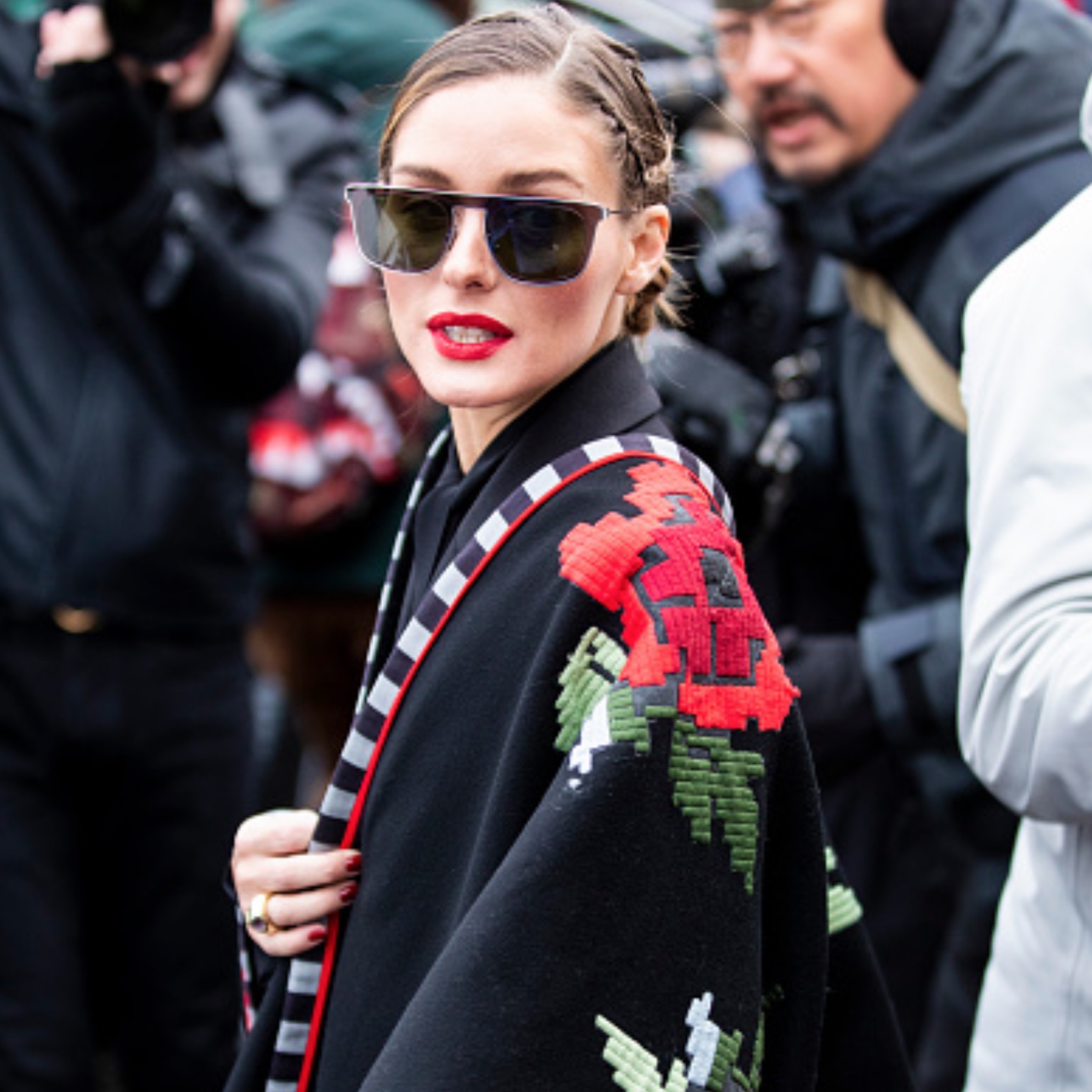 Olivia Palermo during fashion week wearing an embroidered cape
