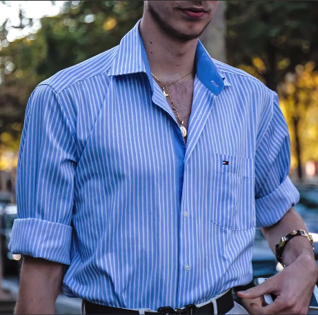 deatil of a fashionista man in the streets of Florence wearing a striped button down shirt
