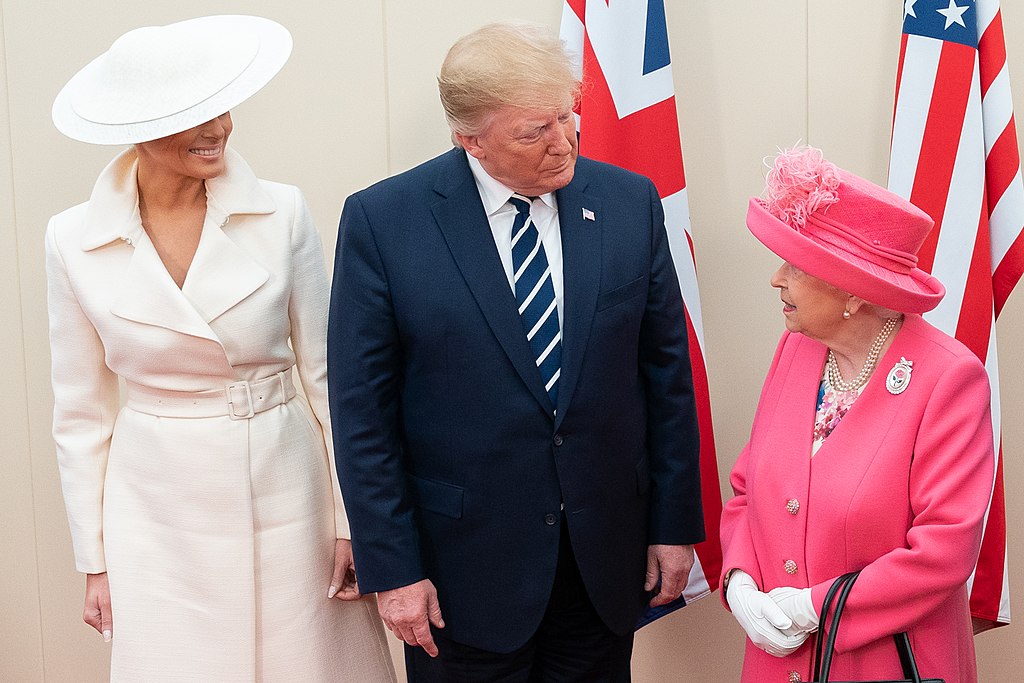 Queen Elizabeth wearing a pink tweed skirt suit at the side of President Trump and the first lady, Melania