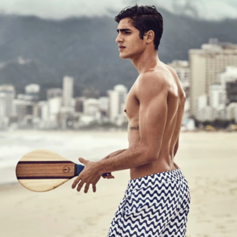 Young man playing Frescobol on the beach of Rio de Janeiro, Brazil