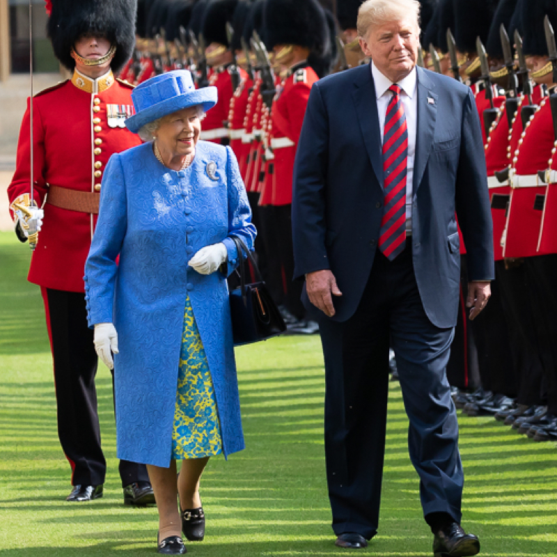 Queen Elizabeth II and Donald Trump in a guard parade wher she is wearing a palm leaf brooch