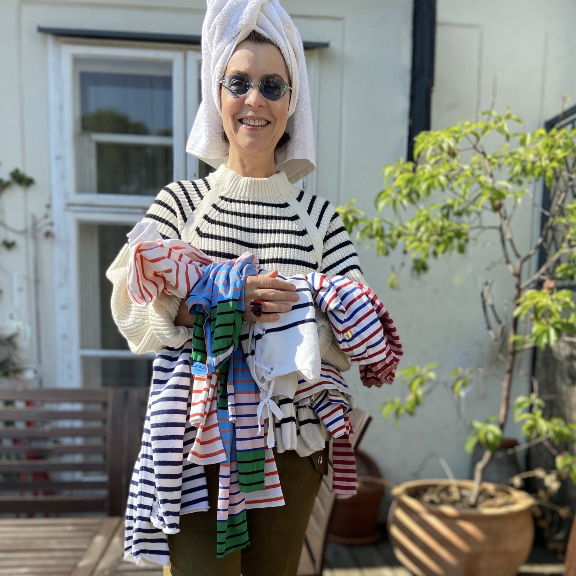 Selma schönburg, editor-in-chief of Notorious mag wearing striped pullover and holding many striped t-shirts