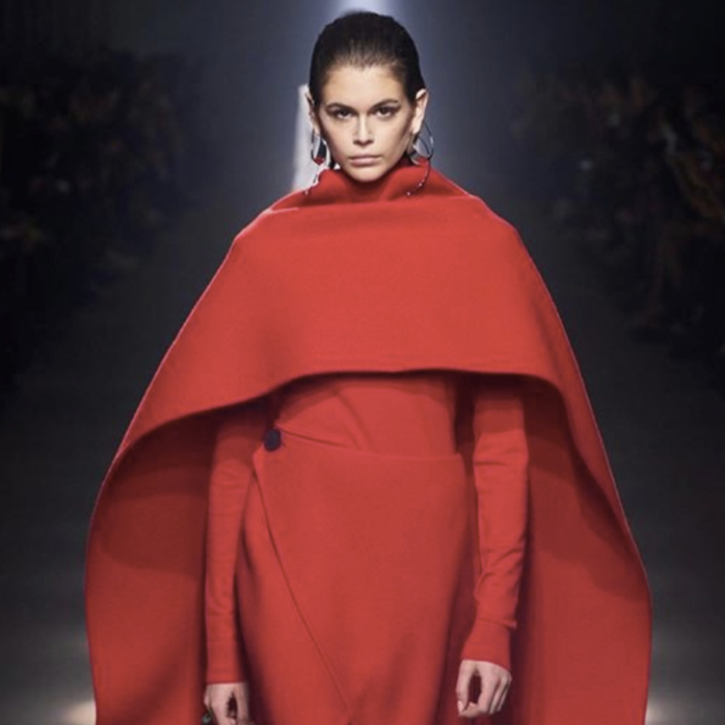 Kaia Gerber presents a Givenchy cape, one of the hottest coat trends for fall 2020.