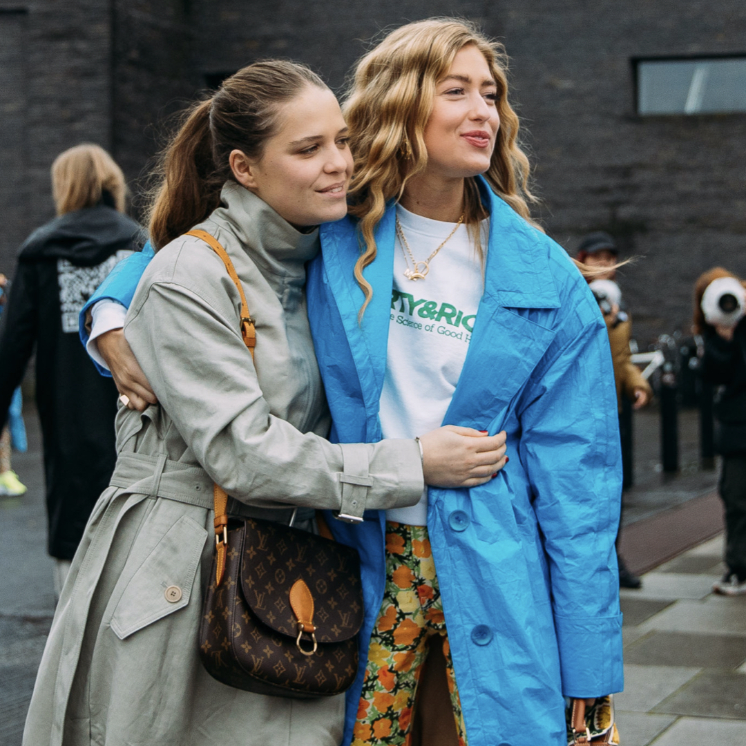 two fashionistas hugging while are being photographed in the streets of Copenhagen