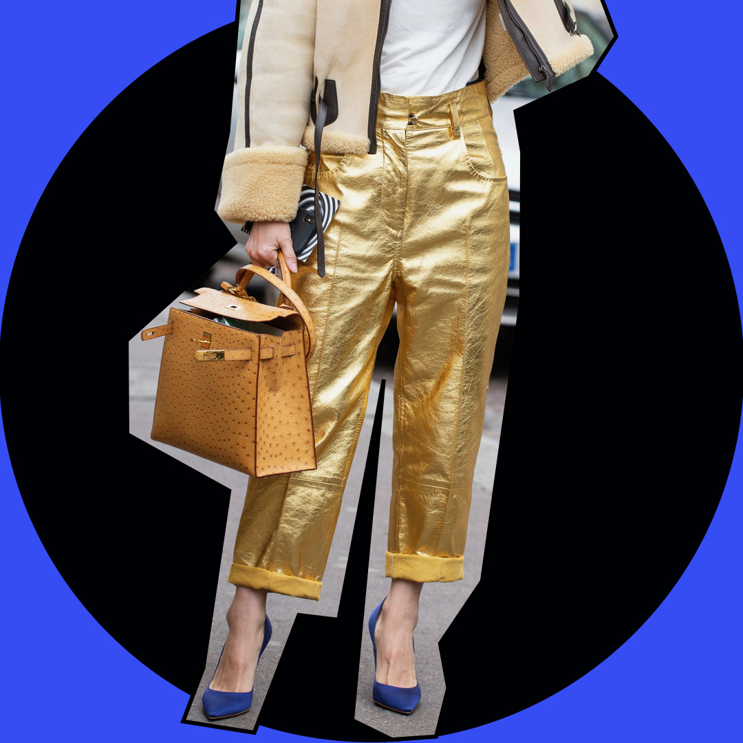 Woman wearing golden outfit and a Birkin, the best investment and desirable bag.