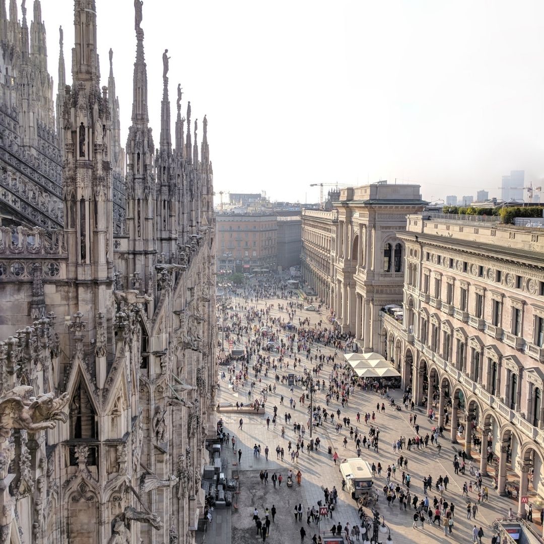 View of a cathedral and a street full of people in Milan, Italy