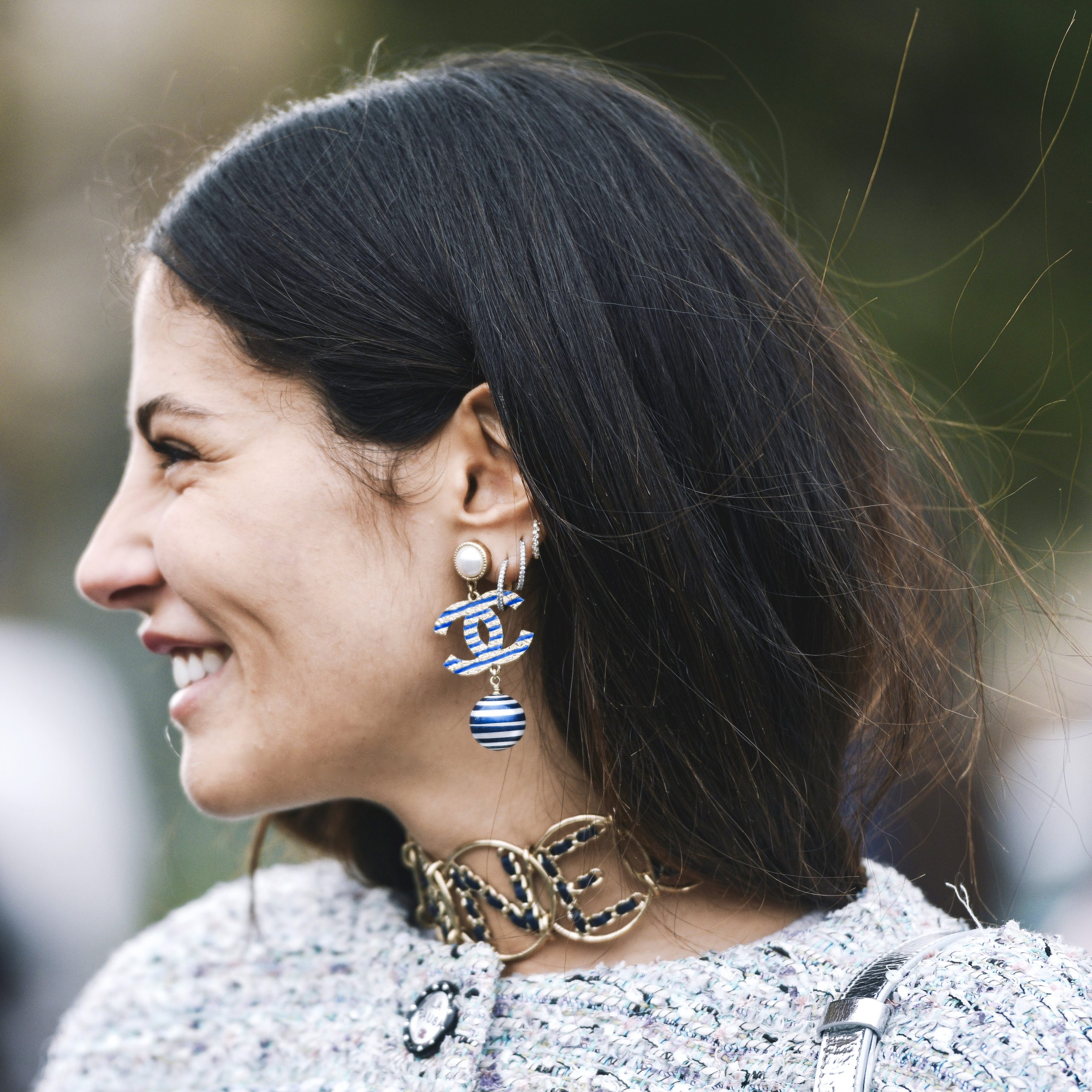 fashionista wearing a earring and necklace from Chanel