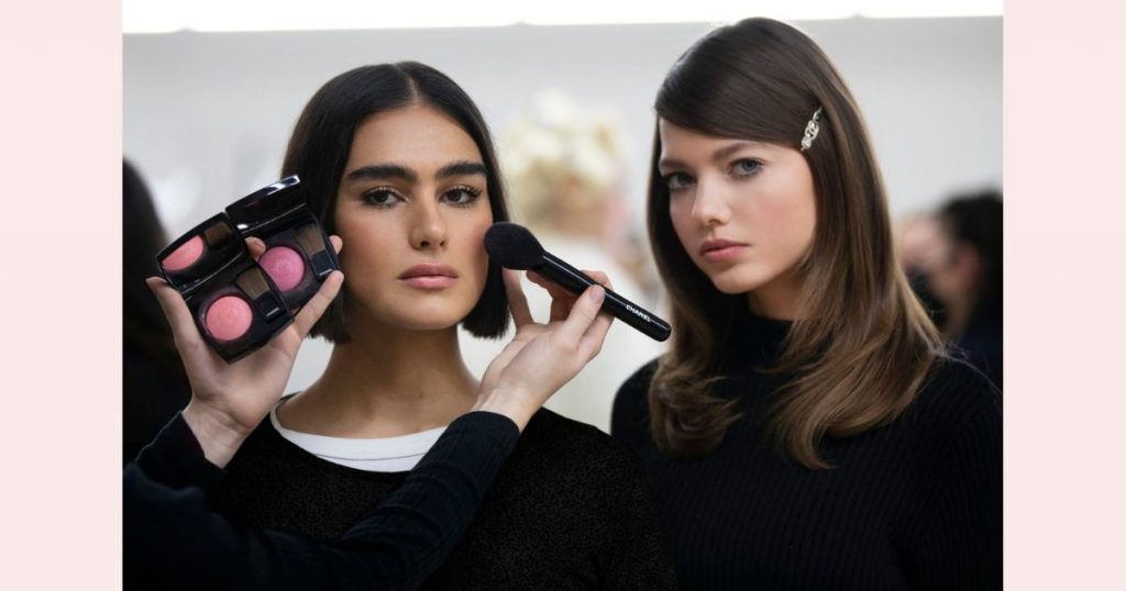 chanel models applying makeup in the backstage of the AW22-23 runway