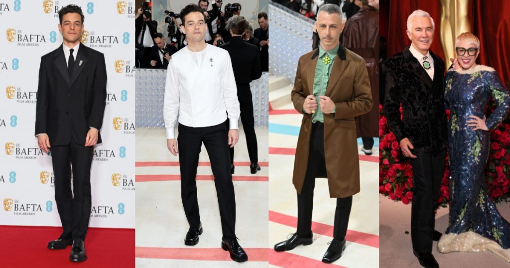 Ramy Malek-Jeremy Strong-Baz Luhrmann-in Prada wearing brooches and necklaces