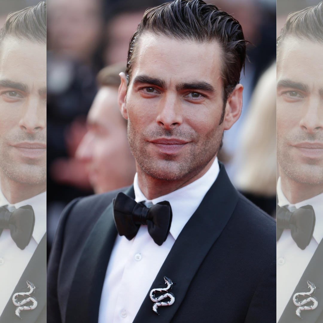 Jon Kortajarena in the Cannes Festival wearing a black tie and a brooch from Bulgari