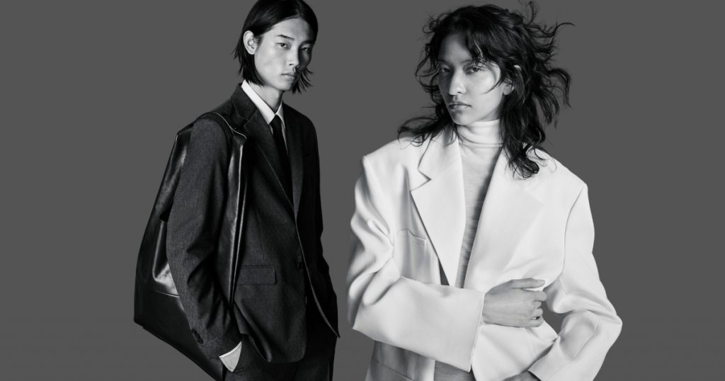 A male and a woman model wearing COS AW23-24 as an example on what to wear for a job interview