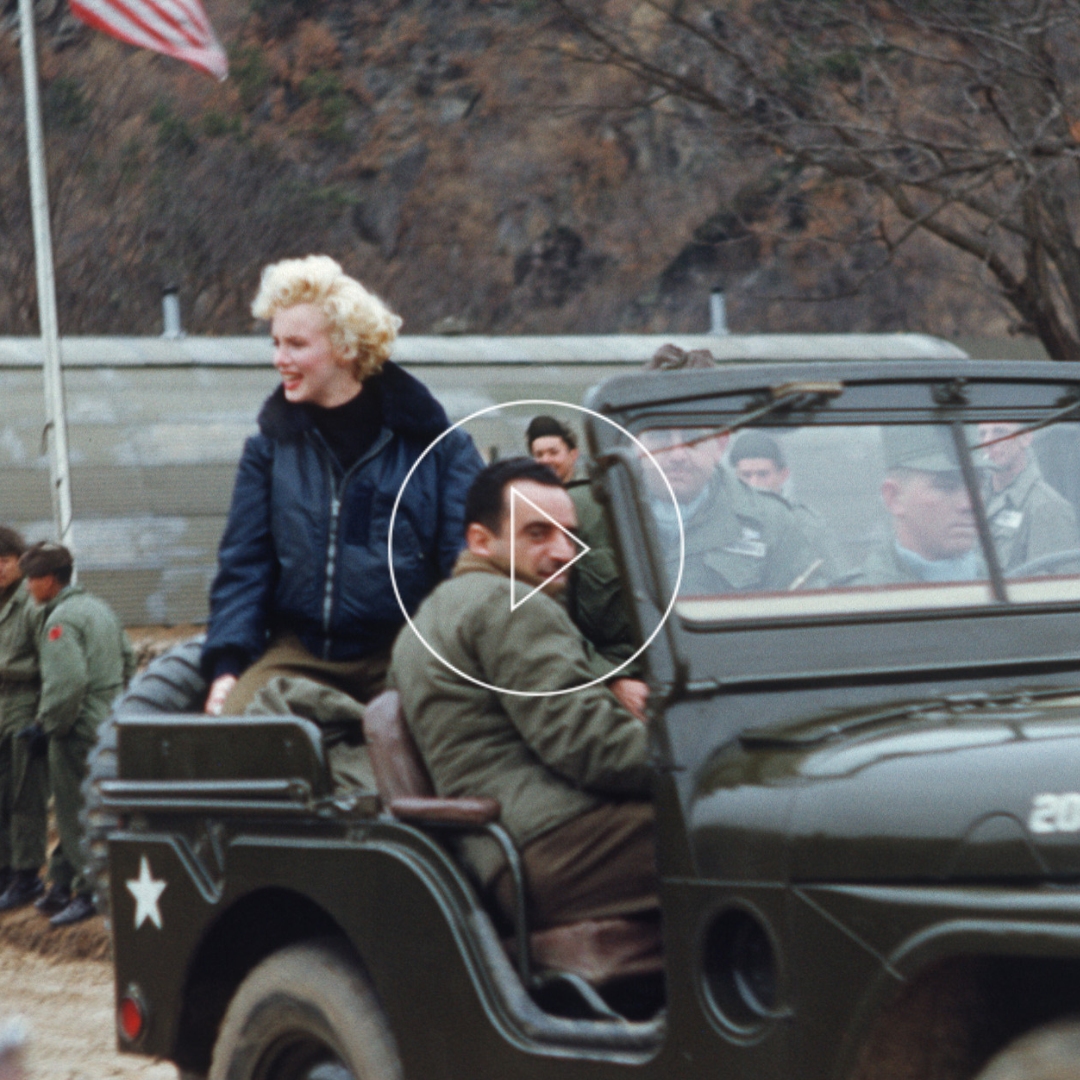 vintage photo featuring actress Marylin Monroe visiting American Troops and wearing a leather bomber Jacket